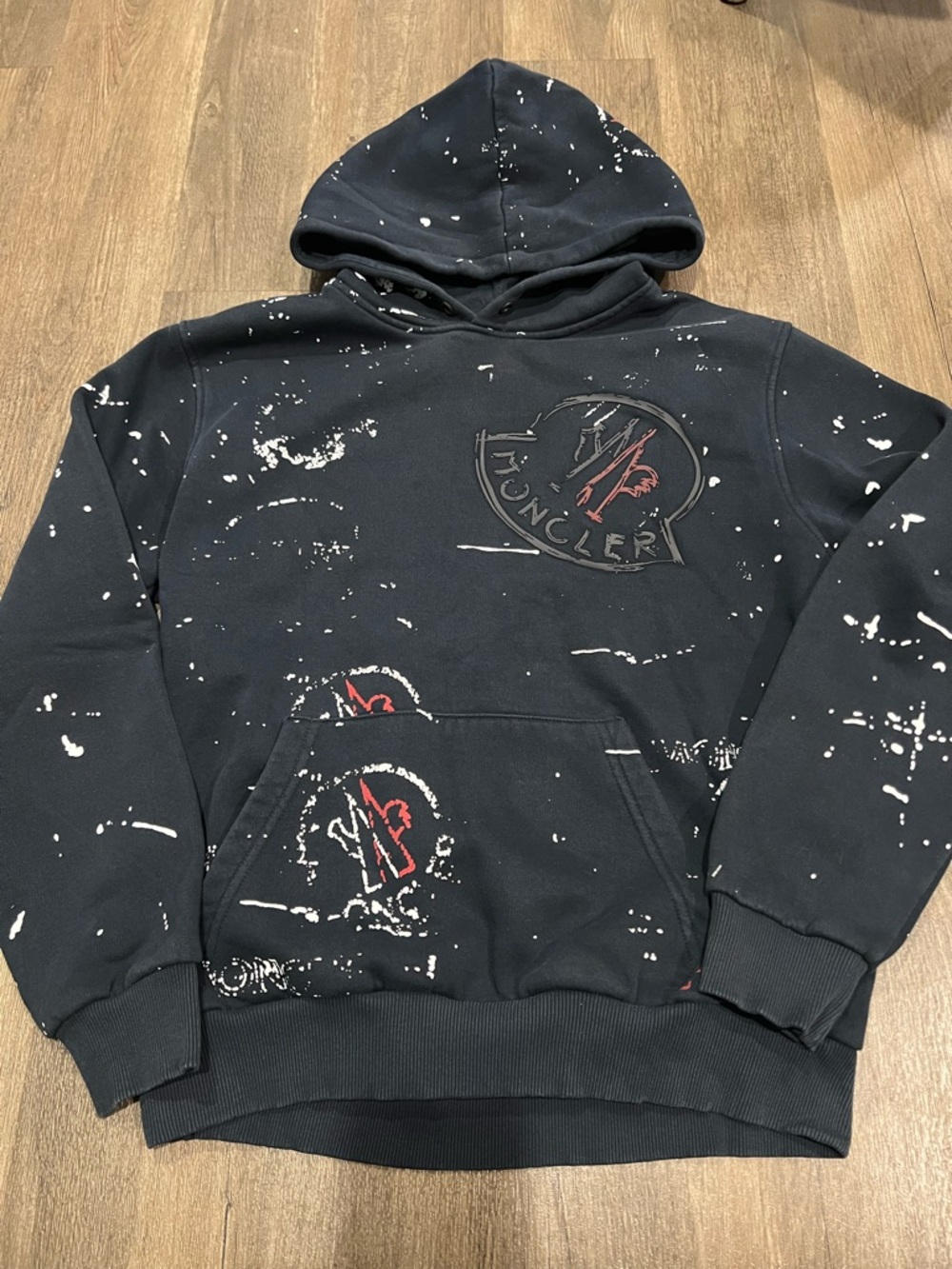 Moncler Black Hoodie with White Paint-Splatter and Red Logo Accents